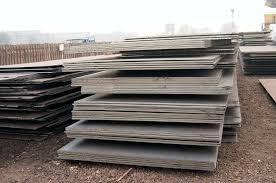 Large steel plates stacked outdoors for construction and industrial fabrication